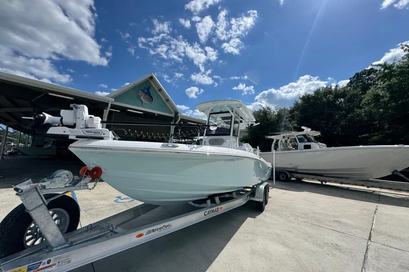Slide: The Image of 2026 Caymas 26 HB boat on trailer under clear blue sky. - 4