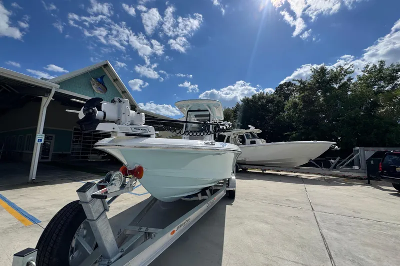 Slide: The Image of 2026 Caymas 26 HB boat on trailer under clear blue sky. - 5