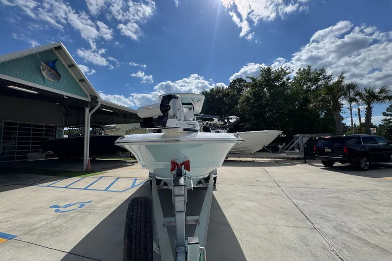 Slide: The Image of 2026 Caymas 26 HB boat on trailer under a sunny sky, parked near a building. - 6