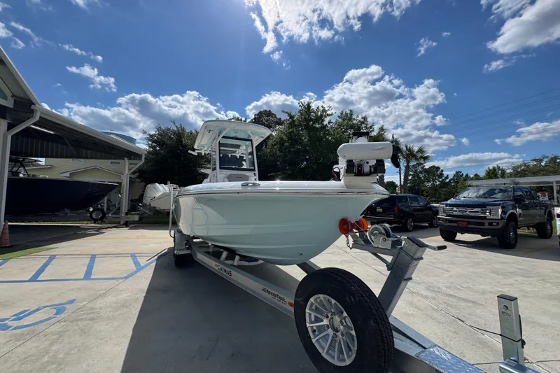 Slide: The Image of 2026 Caymas 26 HB boat on trailer under a sunny sky, parked outdoors. - 7