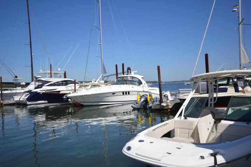 The Image of Boats docked at marina, featuring 2006 Sea Ray 40 Sundancer under clear blue sky. - 0