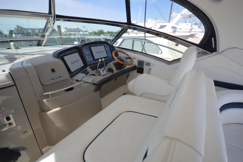 Slide: The Image of Helm of 2006 Sea Ray 40 Sundancer with Garmin navigation displays and plush seating. - 10