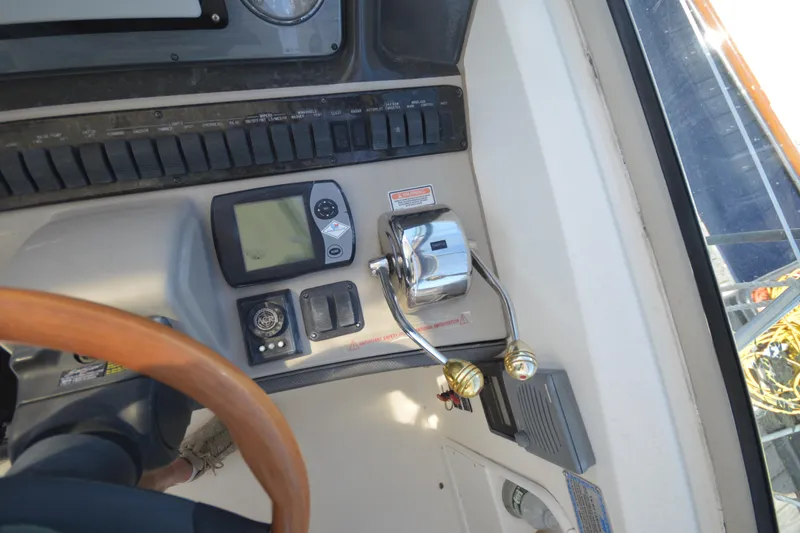 Slide: The Image of Control panel of a 2006 Sea Ray 40 Sundancer boat with throttle and navigation instruments. - 14