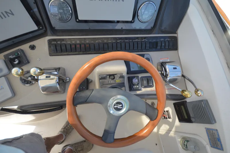Slide: The Image of 2006 Sea Ray 40 Sundancer helm with wooden steering wheel and control panel. - 15