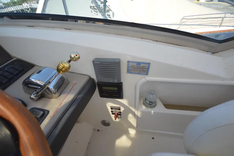Slide: The Image of Helm controls of a 2006 Sea Ray 40 Sundancer yacht with throttle and navigation equipment. - 16
