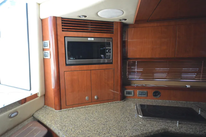Slide: The Image of Luxurious 2006 Sea Ray 40 Sundancer yacht interior with wood cabinetry and modern appliances. - 29