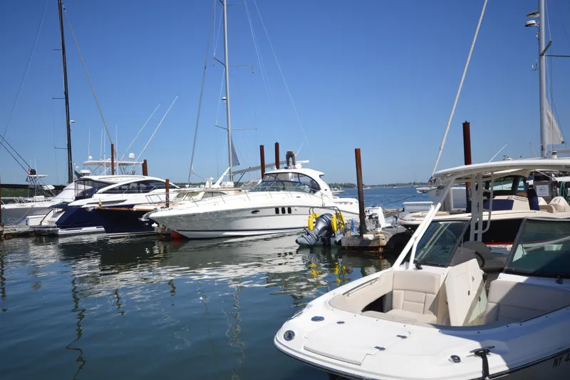 Slide: The Image of Boats docked at a marina, featuring a 2006 Sea Ray 40 Sundancer yacht. - 3