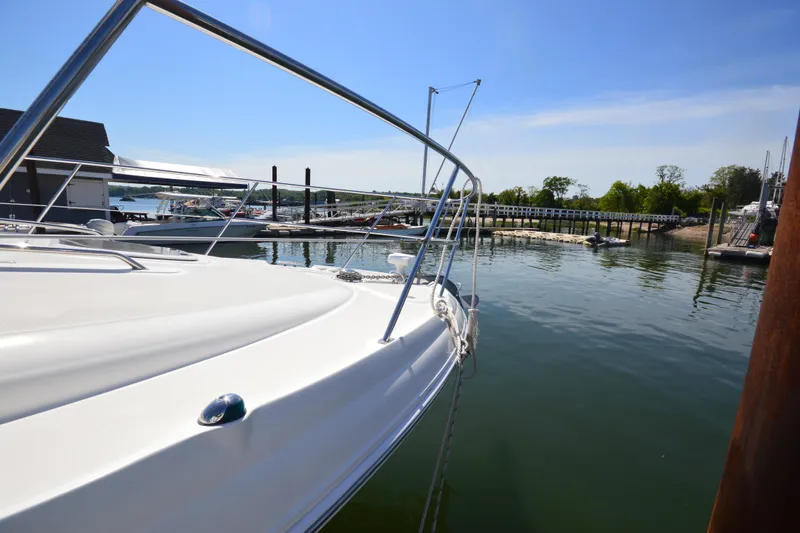 Slide: The Image of 2006 Sea Ray 40 Sundancer yacht docked at a serene marina. - 33