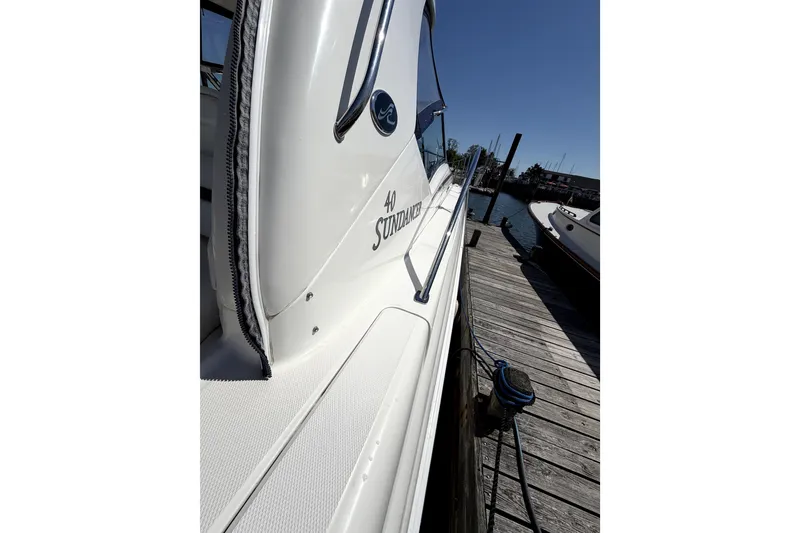 Slide: The Image of 2006 Sea Ray 40 Sundancer yacht docked at marina under clear blue sky. - 40