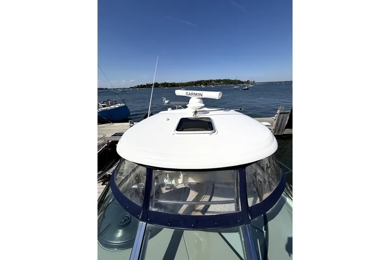 Slide: The Image of 2006 Sea Ray 40 Sundancer yacht docked by the water on a sunny day. - 42