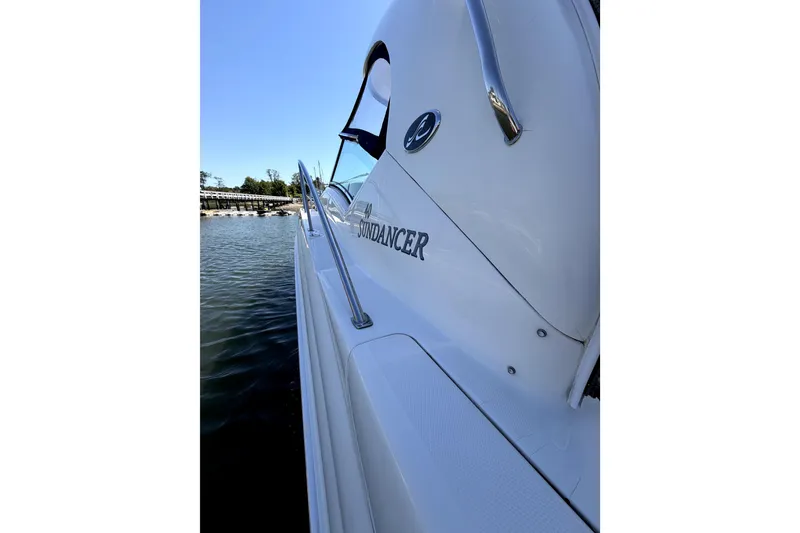 Slide: The Image of 2006 Sea Ray 40 Sundancer yacht docked on calm water under clear blue sky. - 43