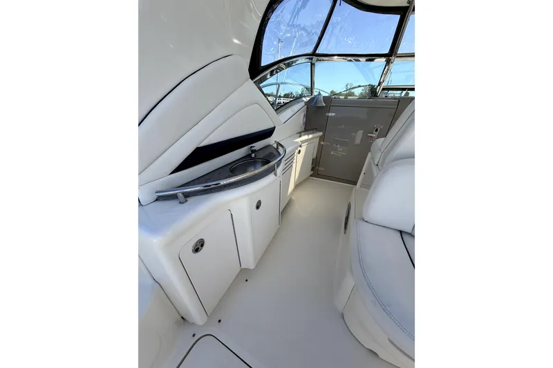 Slide: The Image of Interior of 2006 Sea Ray 40 Sundancer yacht with sleek white seating and compact kitchenette. - 46