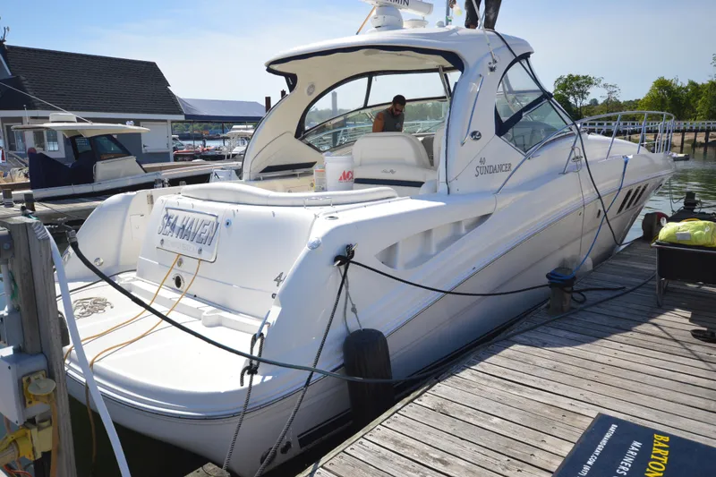 Slide: The Image of 2006 Sea Ray 40 Sundancer yacht docked at marina, featuring sleek design and spacious deck. - 5