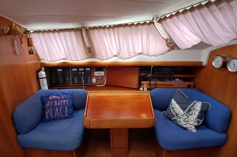 Slide: The Image of Cozy interior of 2002 Jeanneau Sun Odyssey 43 DS with blue seating and decorative pillows. - 10