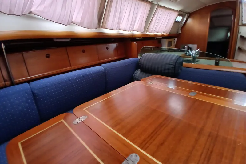 Slide: The Image of Interior of 2002 Jeanneau Sun Odyssey 43 DS yacht with wooden table and blue seating. - 14