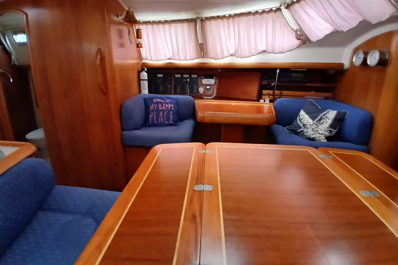 Slide: The Image of Interior of 2002 Jeanneau Sun Odyssey 43 DS sailboat with wooden furnishings and cozy seating. - 15
