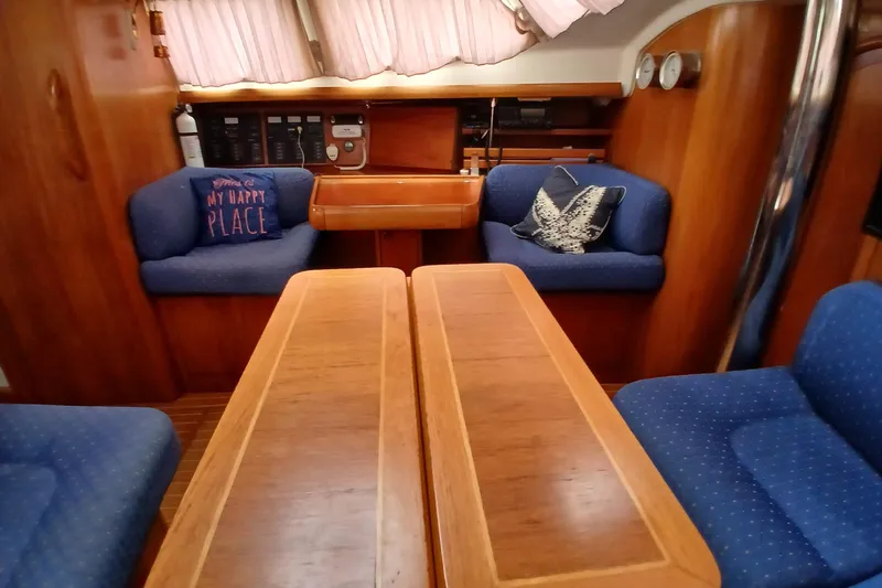 Slide: The Image of Interior of 2002 Jeanneau Sun Odyssey 43 DS sailboat with cozy seating and wooden table. - 16