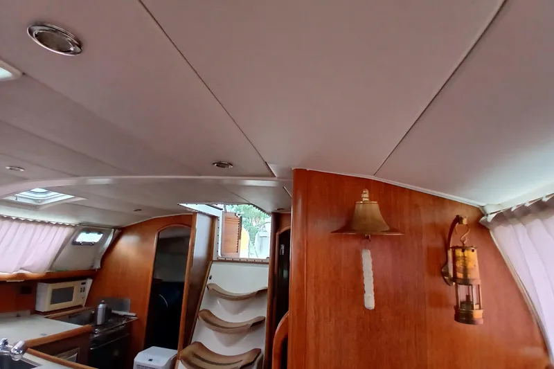 Slide: The Image of Interior of 2002 Jeanneau Sun Odyssey 43 DS sailboat with wood paneling and nautical decor. - 18