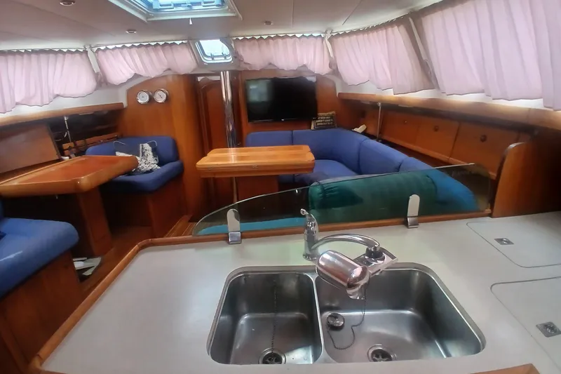Slide: The Image of Interior of 2002 Jeanneau Sun Odyssey 43 DS yacht with kitchen and seating area. - 19