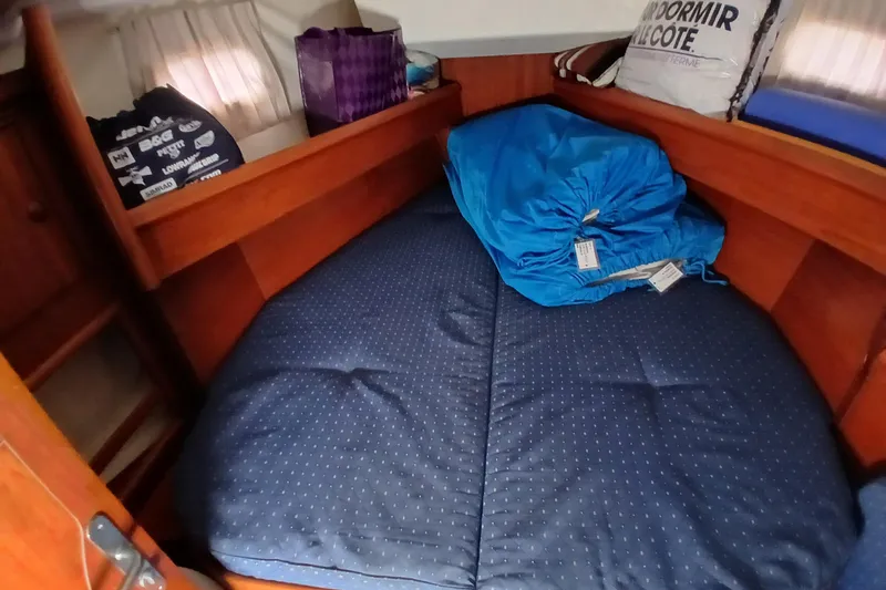Slide: The Image of Cozy cabin interior of 2002 Jeanneau Sun Odyssey 43 DS sailboat with blue bedding. - 27