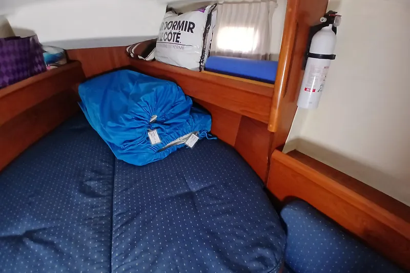 Slide: The Image of Cozy cabin interior of 2002 Jeanneau Sun Odyssey 43 DS sailboat with bedding and fire extinguisher. - 28