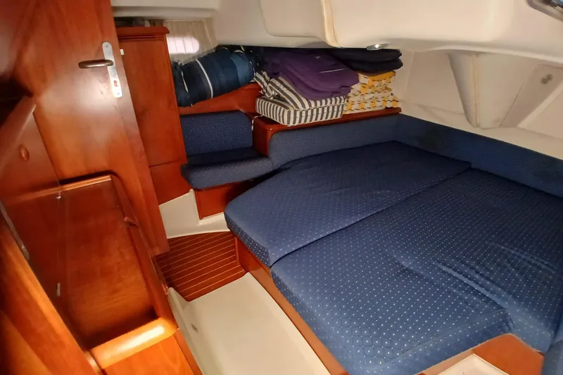 Slide: The Image of Cozy cabin interior of 2002 Jeanneau Sun Odyssey 43 DS sailboat with blue upholstery. - 30