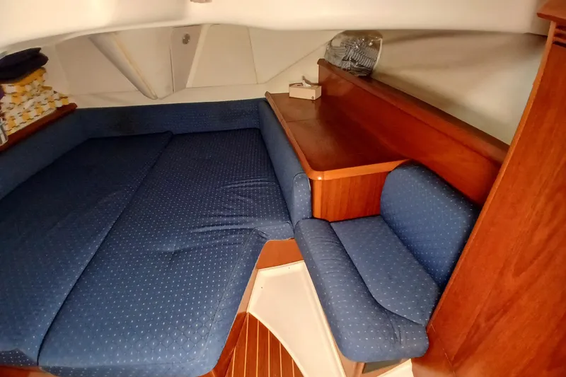 Slide: The Image of Interior cabin of 2002 Jeanneau Sun Odyssey 43 DS with blue upholstery and wooden furnishings. - 31