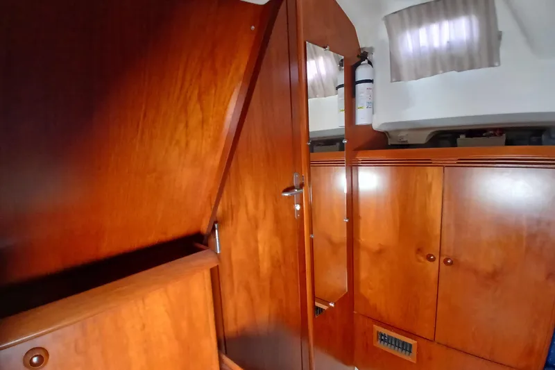 Slide: The Image of Interior of 2002 Jeanneau Sun Odyssey 43 DS with wooden cabinetry and mirror. - 32