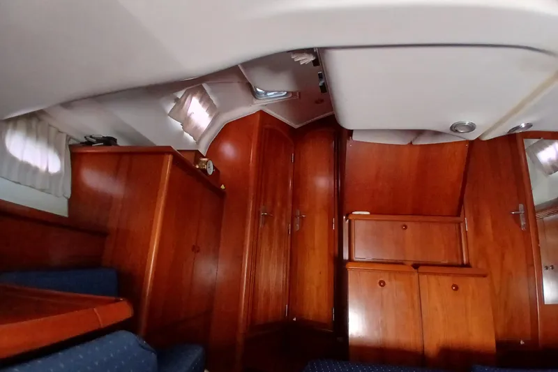 Slide: The Image of Interior of 2002 Jeanneau Sun Odyssey 43 DS sailboat with wooden cabinetry and seating. - 33