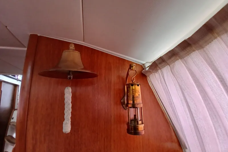 Slide: The Image of Interior of 2002 Jeanneau Sun Odyssey 43 DS with nautical bell and vintage lantern. - 40