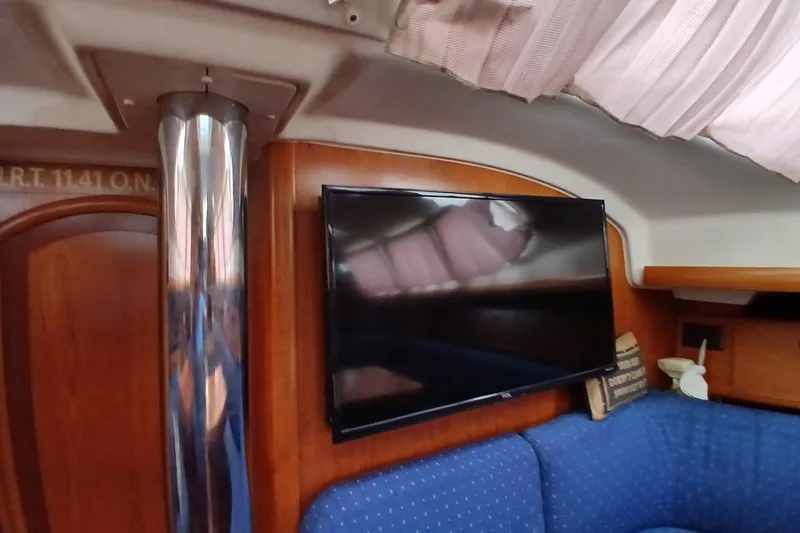Slide: The Image of Interior of 2002 Jeanneau Sun Odyssey 43 DS with TV and blue seating. - 41