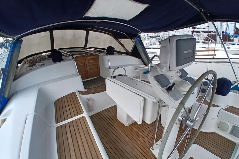 Slide: The Image of Cockpit of 2002 Jeanneau Sun Odyssey 43 DS sailboat with steering wheel and navigation equipment. - 42