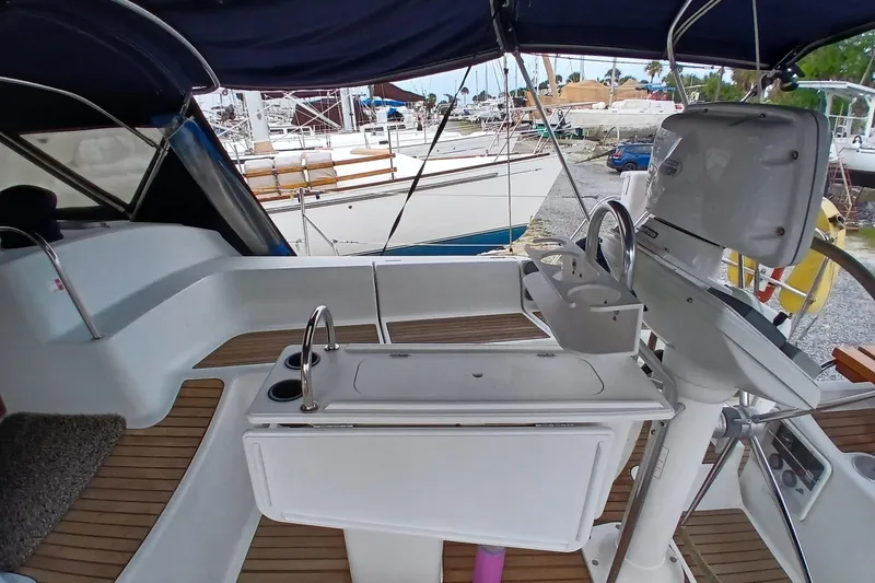 Slide: The Image of Cockpit of 2002 Jeanneau Sun Odyssey 43 DS sailboat with steering wheel and seating area. - 43