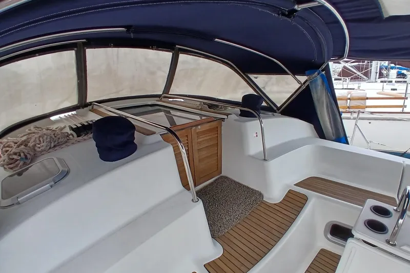 Slide: The Image of Cockpit of 2002 Jeanneau Sun Odyssey 43 DS sailboat with wooden flooring and canopy. - 44