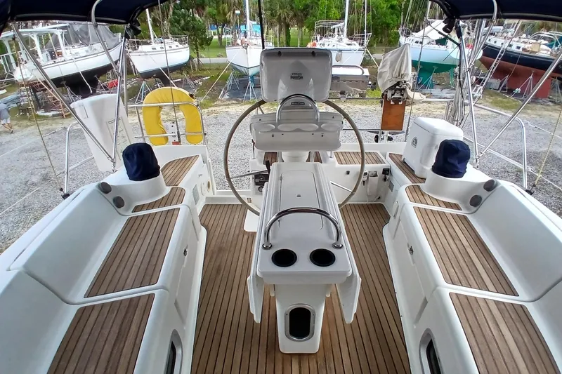 Slide: The Image of Cockpit of 2002 Jeanneau Sun Odyssey 43 DS sailboat with wooden seating and steering wheel. - 45