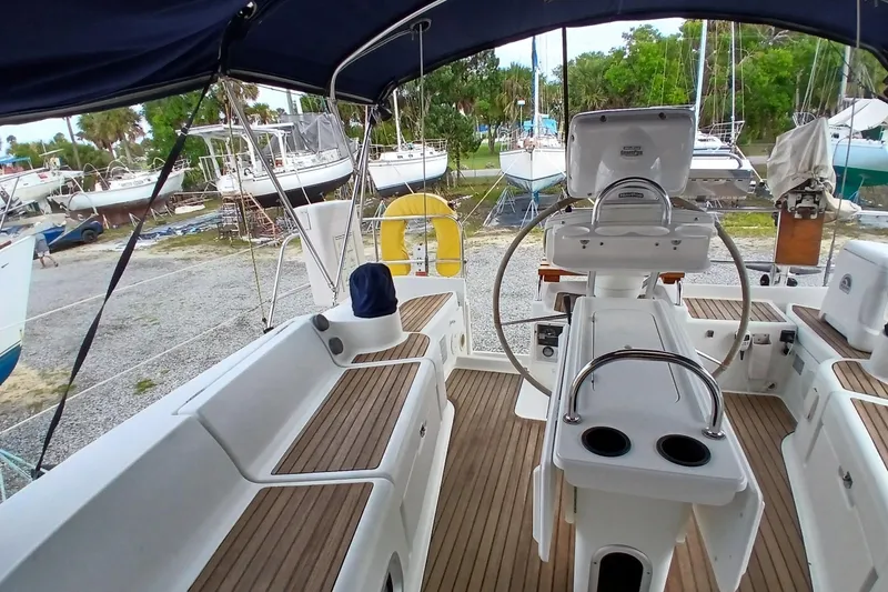 Slide: The Image of Cockpit of 2002 Jeanneau Sun Odyssey 43 DS sailboat with wooden deck and steering wheel. - 46