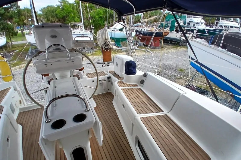 Slide: The Image of Cockpit of 2002 Jeanneau Sun Odyssey 43 DS sailboat with teak flooring and steering wheel. - 47
