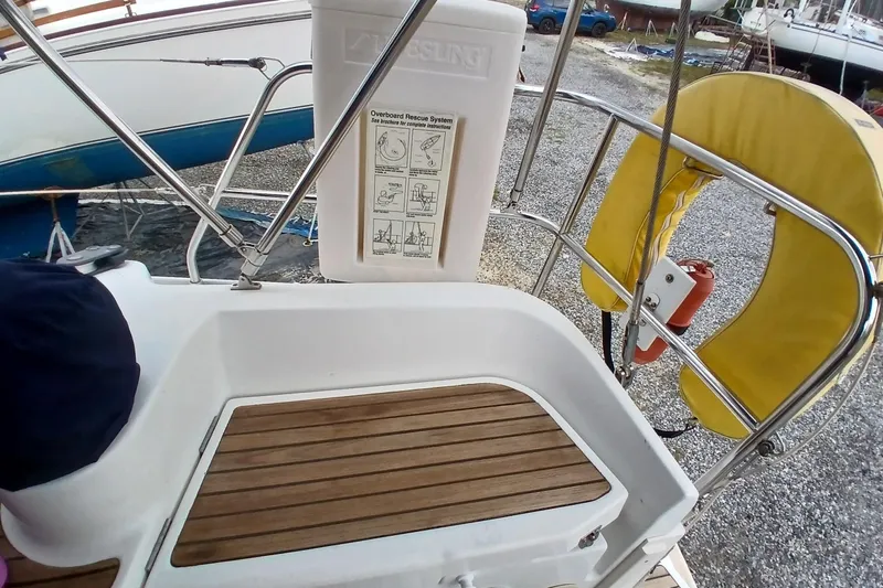 Slide: The Image of Cockpit of 2002 Jeanneau Sun Odyssey 43 DS with safety equipment and teak flooring. - 49