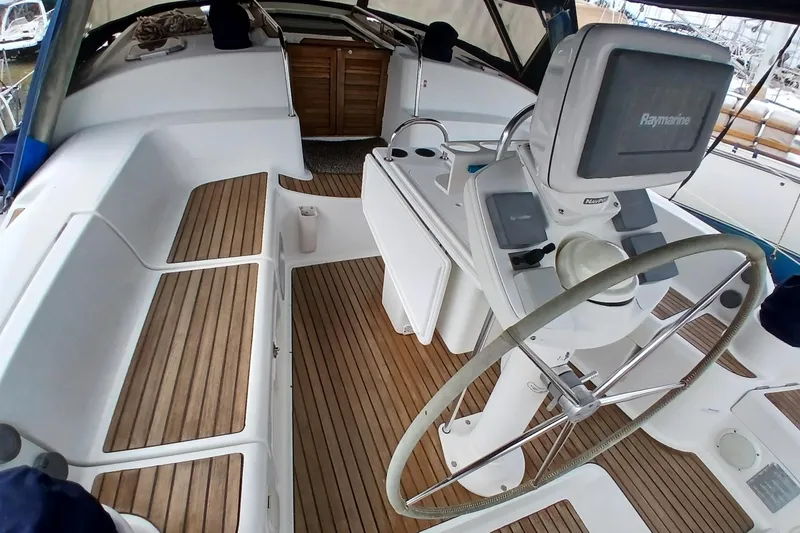 Slide: The Image of Cockpit of 2002 Jeanneau Sun Odyssey 43 DS sailboat with steering wheel and navigation equipment. - 5