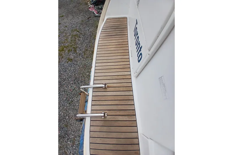 Slide: The Image of Teak deck of 2002 Jeanneau Sun Odyssey 43 DS sailboat with swim ladder. - 51