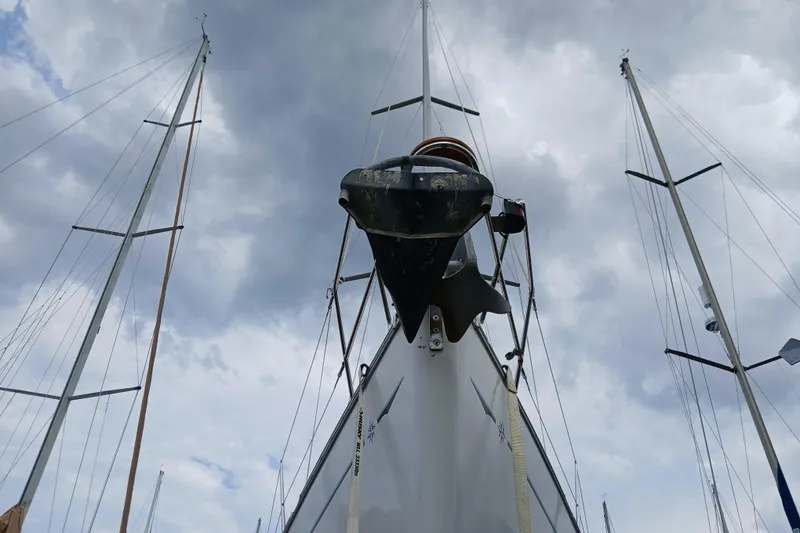 Slide: The Image of Jeanneau Sun Odyssey 43 DS sailboat from 2002, viewed from below against cloudy sky. - 56