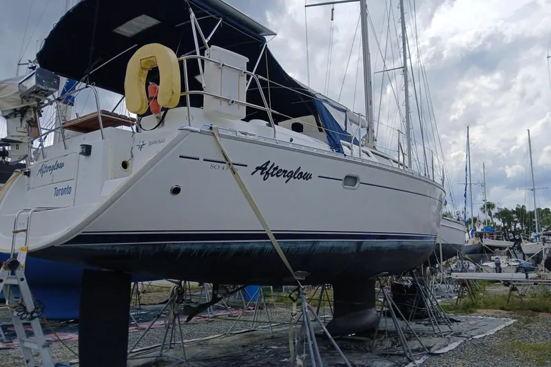 Slide: The Image of Jeanneau Sun Odyssey 43 DS sailboat from 2002 on dry dock, named "Afterglow." - 58