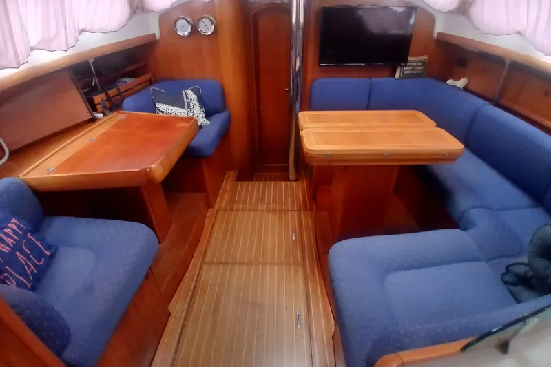 Slide: The Image of Interior of 2002 Jeanneau Sun Odyssey 43 DS yacht with blue seating and wooden tables. - 6