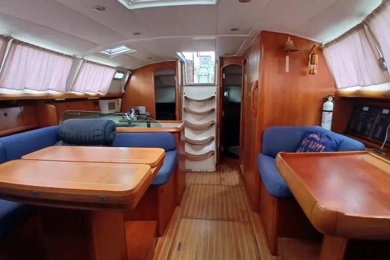 Slide: The Image of Interior of 2002 Jeanneau Sun Odyssey 43 DS sailboat with wooden furnishings and blue seating. - 7