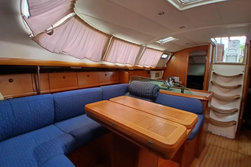 Slide: The Image of Interior of 2002 Jeanneau Sun Odyssey 43 DS yacht with blue seating and wooden table. - 8