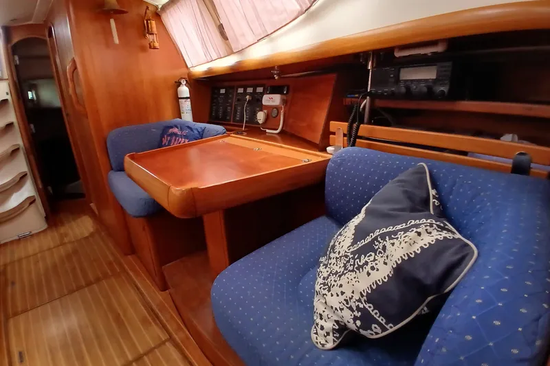 Slide: The Image of Interior of 2002 Jeanneau Sun Odyssey 43 DS yacht with wooden furnishings and blue seating. - 9