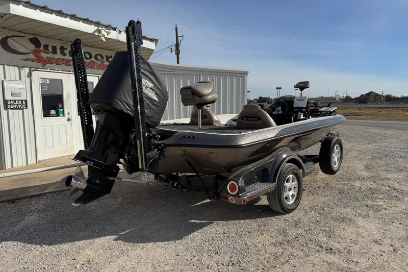 Slide: The Image of 2006 Ranger 519 VX boat parked outside a sales and service shop. - 2