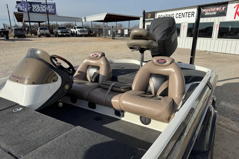 Slide: The Image of 2006 Ranger 519 VX boat with tan seats at a boating center. - 6