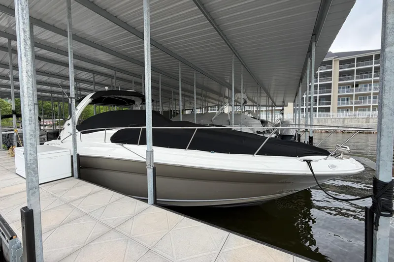 Slide: The Image of 2007 Sea Ray Sundancer 320 docked under a covered marina. - 1