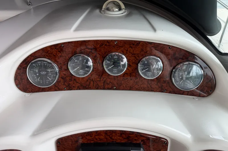 Slide: The Image of Dashboard of a 2007 Sea Ray Sundancer 320 with wood paneling and gauges. - 12